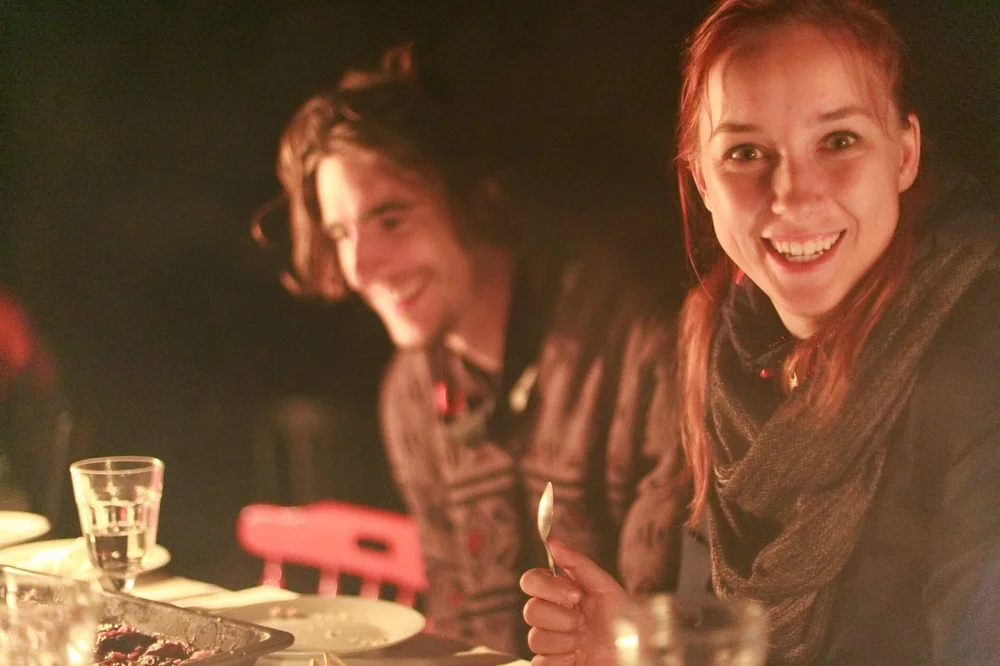 Two participants smiling together over dinner