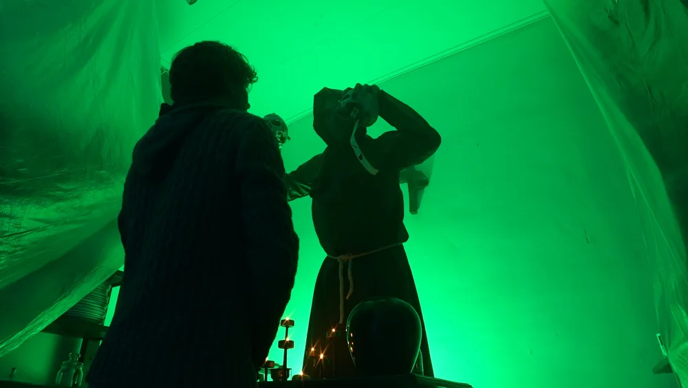 Two participants performing in front of a green screen