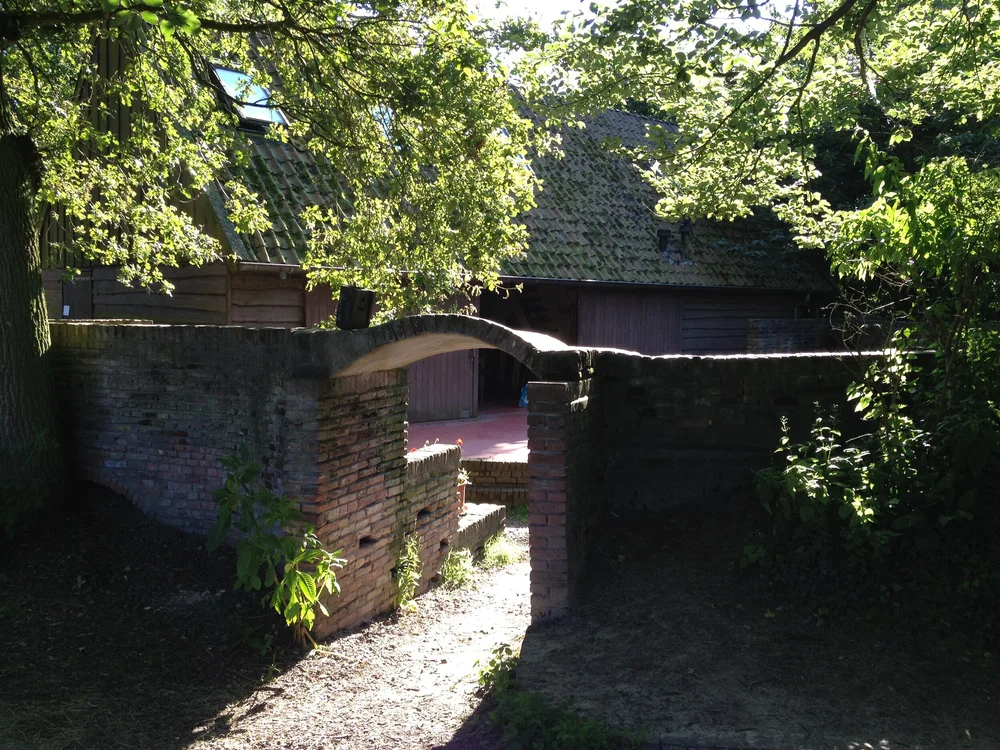 A stone archway at the venue, framed by trees